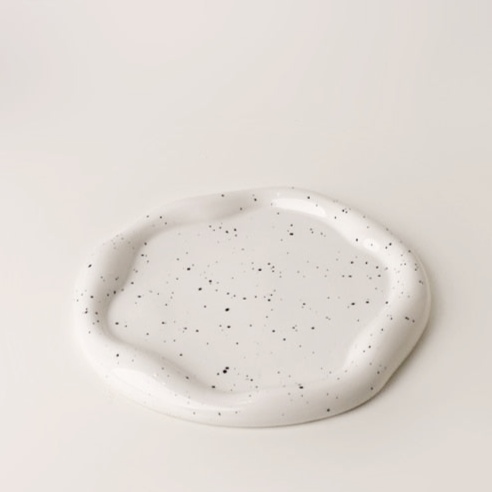Additional view of the irregular ceramic catchall dish.