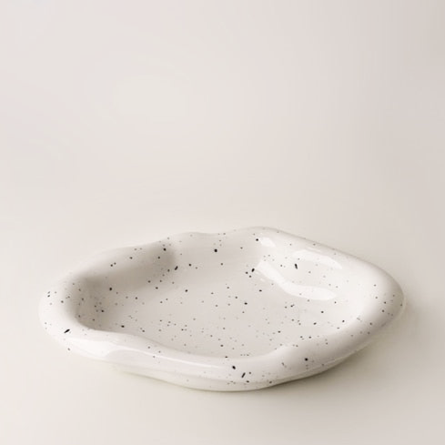 Additional view of the irregular ceramic catchall dish.