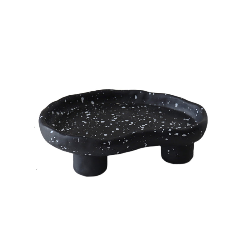 Additional view of the speckled footed resin catchall tray.