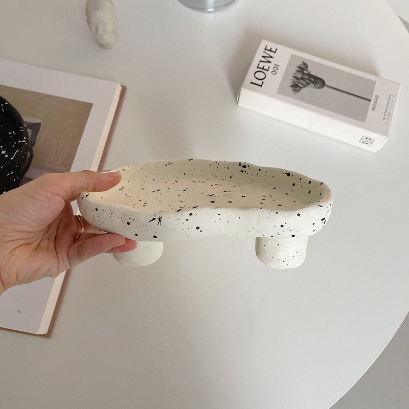 Additional view of the speckled footed resin catchall tray.