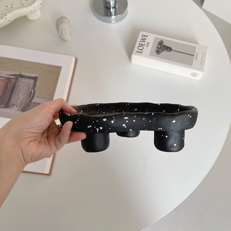 Additional view of the speckled footed resin catchall tray.