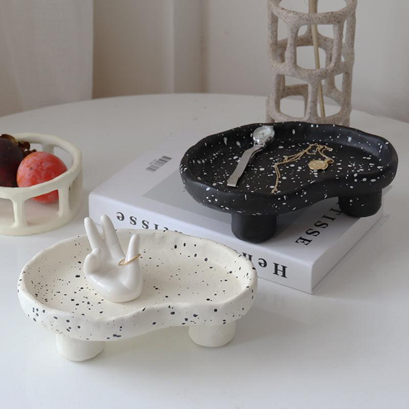 Additional view of the speckled footed resin catchall tray.